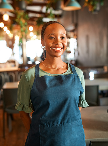 Portrait, black woman or happy barista in cafe, modern startup or restaurant with positive mindset. Smile, coffee shop or waitress in hospitality business with confidence, pride or friendly attitude
