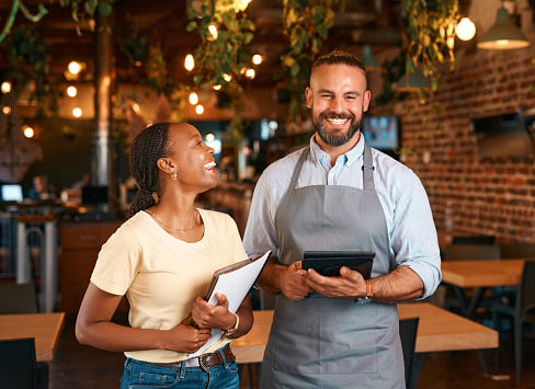 Restaurant, business owner or portrait of happy entrepreneur in a fancy modern store or startup with tablet. Documents, smile or funny black woman leader laughing with manager in coffee shop or cafe