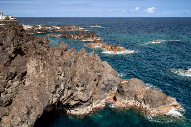 istock Rocky coast, in backround the Bathing complex,  Natural Pools,  paved volcanic pools, converted into swimming pools,  sea surf , Porto Moniz,  Madeira, Portugal, Europe 1502423266