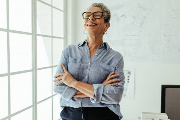 istock Career success: Female design architect stands in her office with a happy smile 1502423535