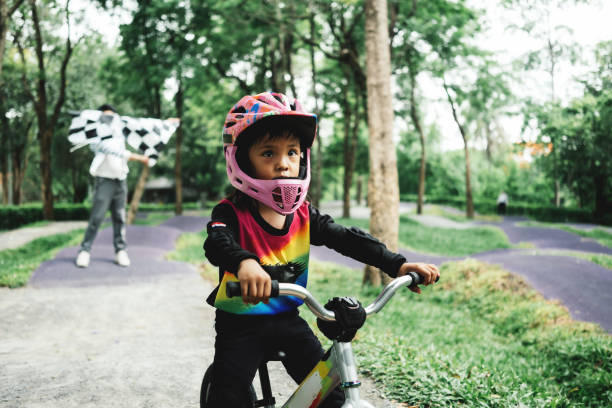 Little girl practice cycling in the park