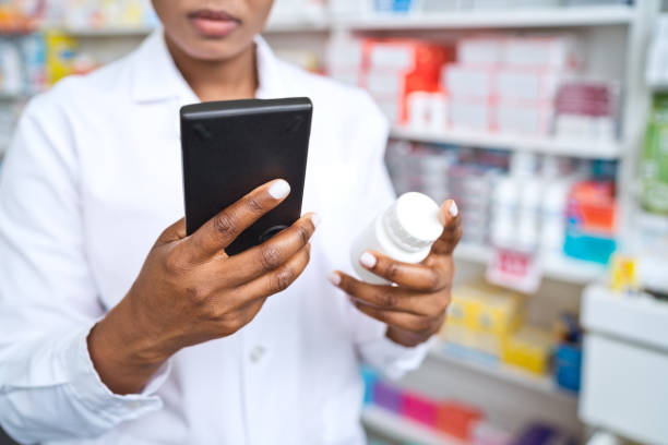 istock Female pharmacist standing in front of shelves in pharmacy 1502425553
