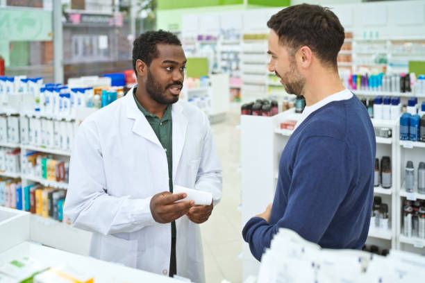 istock Male pharmacist and customer in pharmacy 1502426316