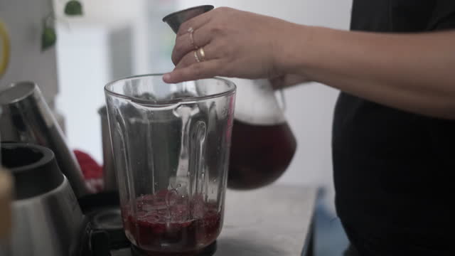 Unrecognizable Hand Putting Liquid Sugar & Tea Into Blender