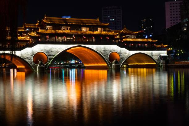 istock Gallery bridge in Chengdu during night with reflecting lights on water 1502431079