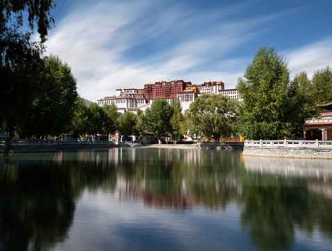 A tranquil lake in Lhasa, Tibet, with the iconic Potala Palace in the background