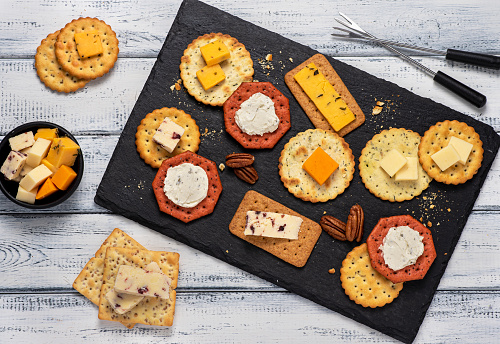 Food photography of cheese, cracker, nuts