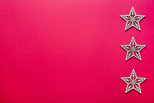 Red background photography of Christmas stars, blank, copy space