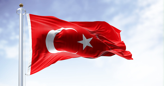 Turkey national flag waving in the wind on a clear day. Red flag with white crescent and a star. 3D illustration render. Fluttering fabric