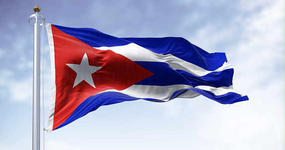 Cuba national flag waving in the wind on a clear day. Five blue and white stripes, a red triangle at the hoist with a white star. 3d illustration render. Fluttering fabric