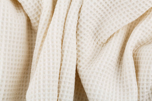istock White corrugated cotton textile - close up of fabric texture. Cotton Fabric Texture. White Clothing Background. Text Space. Abstract background and texture for designers. 1502435793