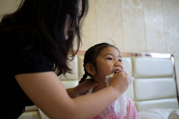 istock mother tying daughter's hair 1502436093