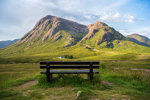 Landscape photography of  mountains, house, bench, meadow