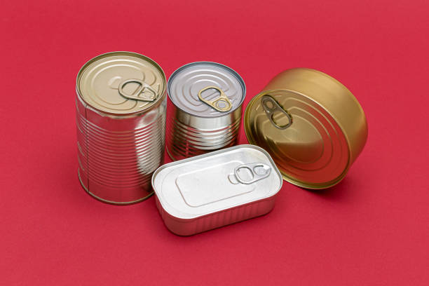 istock Unopened Tin Cans with Blank Edges on Red Background 1502450450