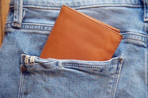 Leather wallet in the back pocket of jeans