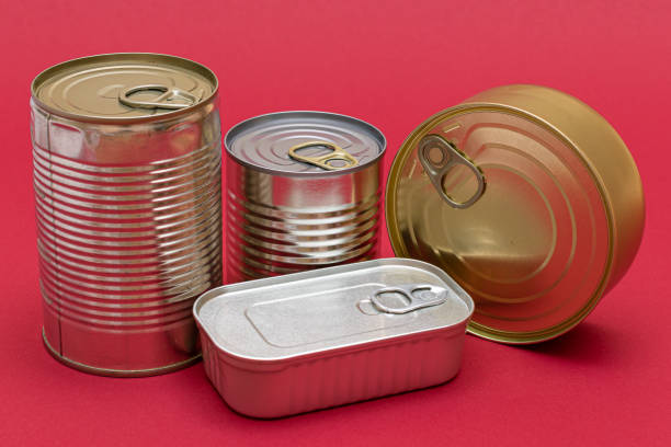 istock Unopened Tin Cans with Blank Edges on Red Background 1502452792