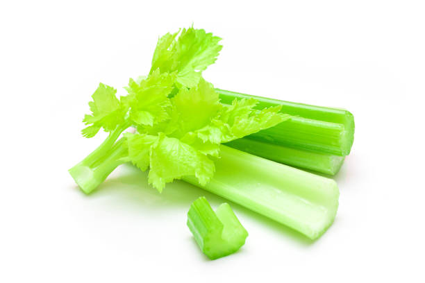 istock Fresh Chopped Celery Sticks and Slices with Leaves and Water Drops Isolated on White Background 1502453728