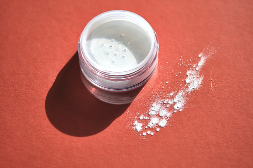 Mineral enzyme powder on a red burgundy background.