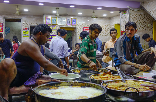 Lahore, Pakistan  - October 31, 2021: Men baking naan in Lahore, Pakistan