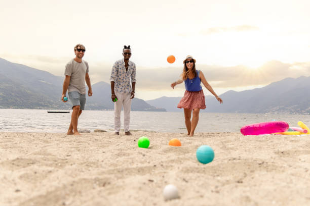 istock Three adults playing boule on the beach by the lake 1502457558
