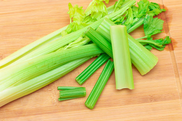 istock Fresh Celery Stem and Chopped Celery Sticks on Wooden Cutting Board 1502458189