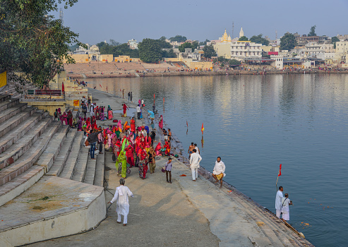 Pushkar, India - Nov 5, 2017. People praying on bank of Pushkar Lake. Pushkar is a pilgrimage site for Hindus and Sikhs, located in State of Rajasthan.