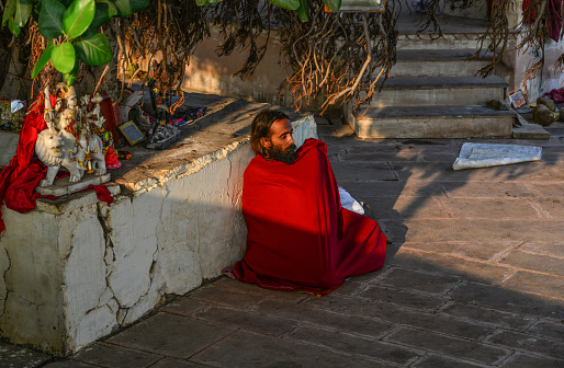 Pushkar, India - Nov 5, 2017. A meditating Sadhu under Bodhi Tree in Pushkar, India. Pushkar is only 11km from Ajmer separated from it by rugged Nag Pahar (Snake Mountain).