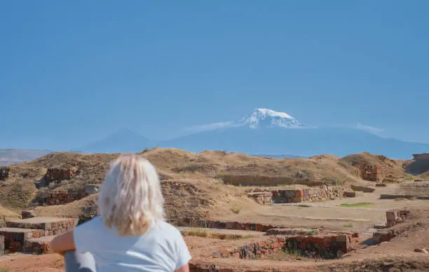 Photo of View from Arin Berd hill and Erebuni fortress to the majestic peak of snowy Ararat. Traveling to popular places, heritage of human history, idea for banner or postcard