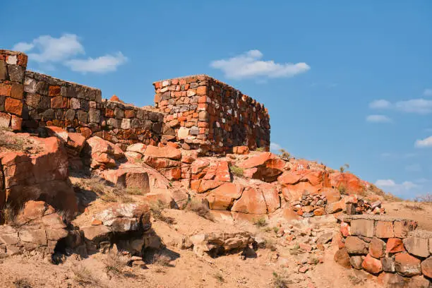 Photo of The ruins of the ancient fortress of Erebuni, the kingdom of Urartu in modern Yerevan, Armenia. Traveling to popular places, heritage of human history, idea for banner or postcard