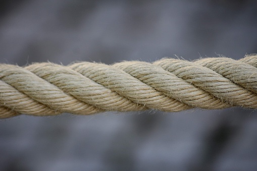 Rope with a tied knot lying on stone surface