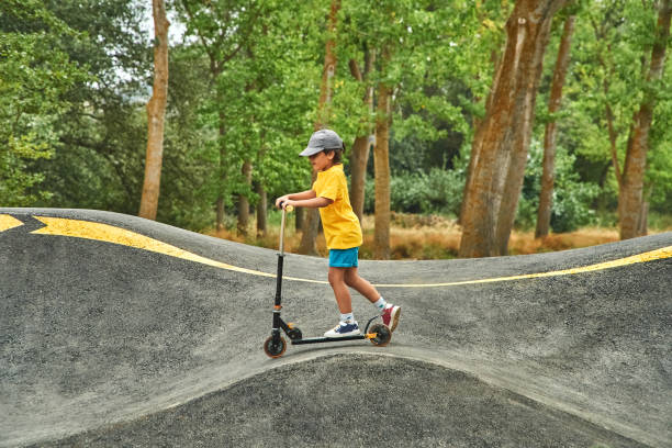 istock Boy riding scooter on a pumptrack at the park 1502467397