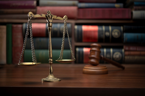 Scales of justice, law books, and gavel