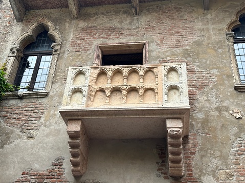 Facade with balcony of historical buildings in the city of Padua in Italy. Typical wall view with architectural details. Brickwork.Travel destination in Italy concept