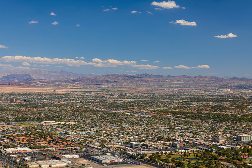 Beautiful aerial view of Las Vegas with mountain landscape on blue sky with white clouds background.  USA.
