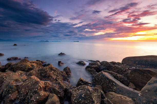 istock Dramatic sunset over rocky beach in Kota Kinabalu 1502487799