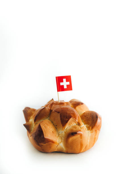 Swiss national holiday celebrated annually on August 1st with traditional bread called in German Augustweggen. Isolated on white, copy space.
