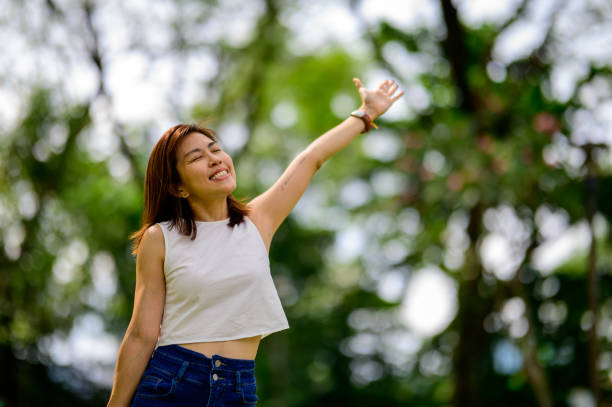 istock A Breath of Serenity: An Asian Woman's Blissful Respite in the Park 1502495163