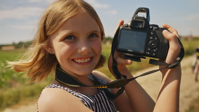SLO MO Girl with a DSLR Camera Joyfully Clicks and Shares her Field Adventures