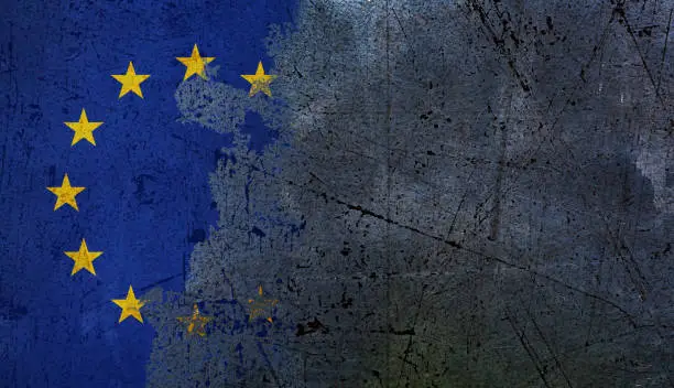 Photo of Ominous moment for Europe: EU flag being erased from a scratched grungey concrete wall, with copy space