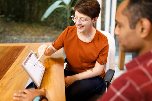 istock Woman discussing a project with her coworker 1502505266