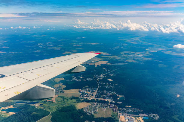 istock View from the airplane window at a beautiful cloudy sky and the airplane wing 1502509485