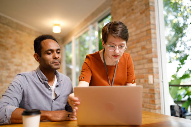 istock IT woman checking her coworker's laptop 1502512514