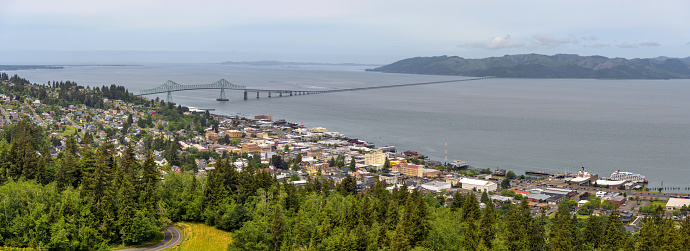 A panoramic Spring day overview of port city Astoria and the Astoria-Megler Bridge, near the mouth of Columbia River at the Pacific Ocean. Oregon, USA.