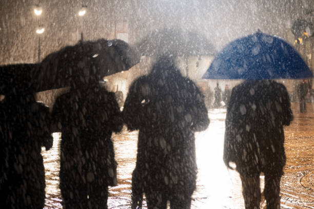 istock backlit motion blurred people on a rainy day in the city 1502530023