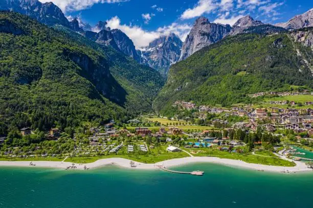 An aerial view of Lago di Molveno, Italy, with the mountains and a small village in the background