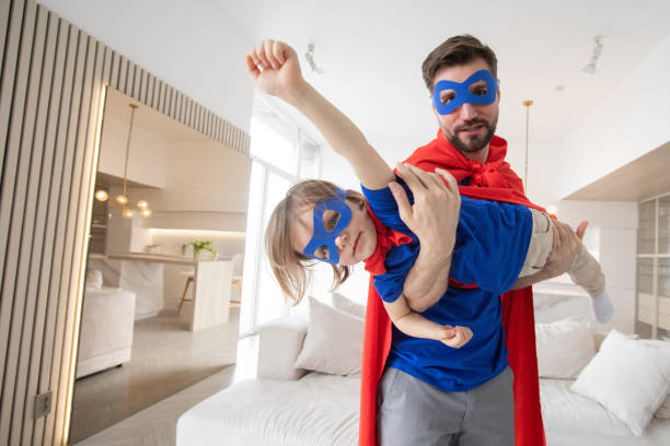 Father and son play superhero
