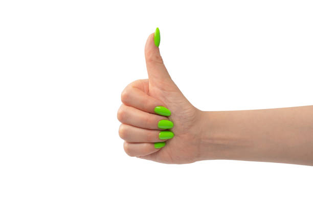 Hand of a woman with green naols hold some tiny or thin object, isolated on a white background.