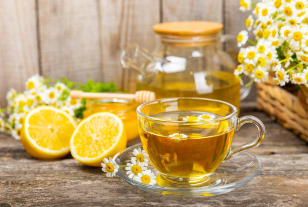 istock Chamomile tea in a cup on a brown textured background. Natural hour with chamomile flowers. Herbal tea. Natural healer concept. Healthy detox drink.Close up. Place for text. Copy space. 1502537748