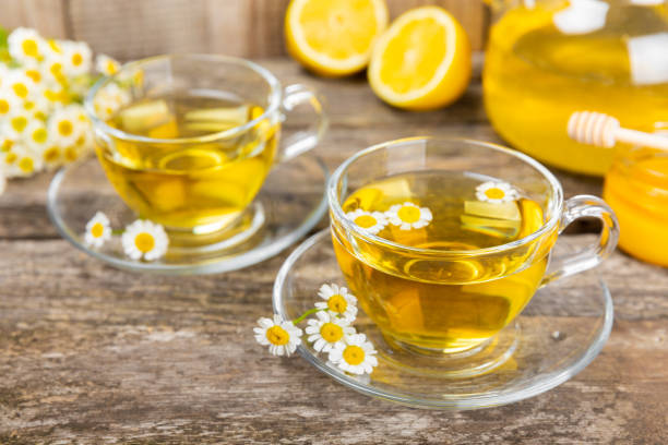 istock Chamomile tea in a cup on a brown textured background. Natural hour with chamomile flowers. Herbal tea. Natural healer concept. Healthy detox drink.Close up. Place for text. Copy space. 1502542219
