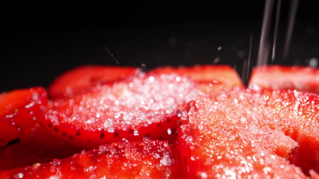 Diced ripe strawberries sprinkled with sugar. Dolly shot